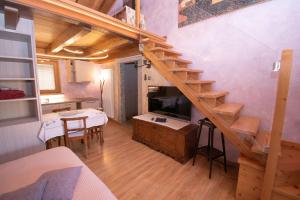 a living room with a staircase and a dining room at Albergo Ristorante Conca Azzurra in Colico