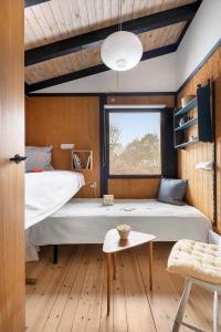 a bedroom with a large bed and a window at 1673-Hundested-Moller-Ager-7 in Hundested