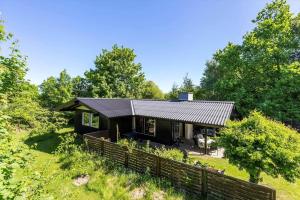 a house on a hill with a fence at 1673-Hundested-Moller-Ager-7 in Hundested