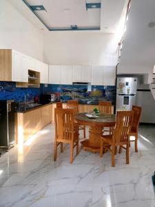 a kitchen with a table and chairs and a refrigerator at CoCo SEA in Mui Ne