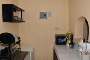 a kitchen with a counter with a microwave at Maya Haven in Ukunda