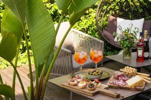 a table with food and two glasses of wine at Hotel Sant'Andrea in Santa Margherita Ligure