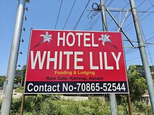 a red sign for a hotel white lily at White Lily in Guwahati