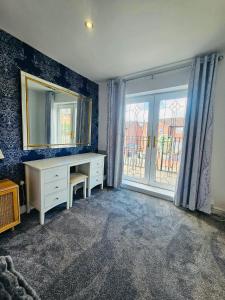 a room with a desk and a mirror and a window at Luxury Home with Pool in Barnsley