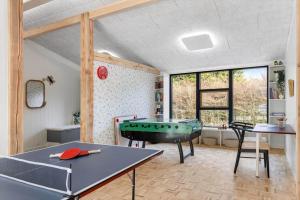 a room with a ping pong table in it at 8882-Glesborg-Kaervejen-5 in Fjellerup Strand