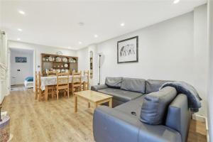 a living room with a couch and a table at The Stables in Great Horkesley