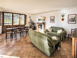a living room with a couch and a table and chairs at Villa Le More by Interhome in Penna in Teverina +28 photos