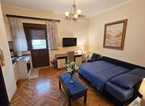 a living room with a bed and a table at Nexus Apartment in Podgorica