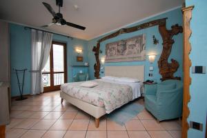 a bedroom with a large bed and blue walls at Albergo Ristorante Conca Azzurra in Colico