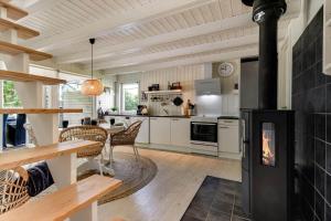 a kitchen and dining room with a fireplace in a house at C11638-Hemmet-Vester-Faelled-49 in Hemmet