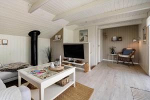 a living room with a couch and a tv at C11638-Hemmet-Vester-Faelled-49 in Hemmet