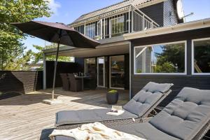 a patio with two lounge chairs and an umbrella at C11638-Hemmet-Vester-Faelled-49 in Hemmet
