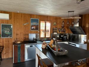 a kitchen with wood paneling and a counter top at Villa Serena offrez vous une parenthese in Le Porge