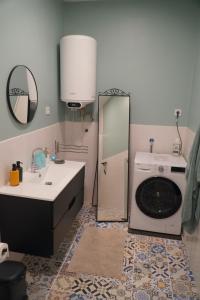 a bathroom with a sink and a washing machine at Casa-Stella-Azores in Capelas