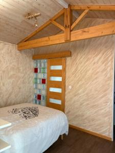 a bedroom with a bed and a wooden ceiling at Villa Serena offrez vous une parenthese in Le Porge +24 photos