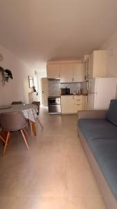 a kitchen with a couch and a table in a room at Kazeta A-14,broj 28, Gajac in Skunca