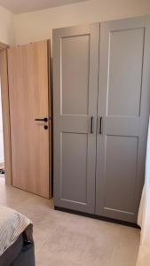 a bedroom with a closet and a door at Kazeta A-14,broj 28, Gajac in Skunca