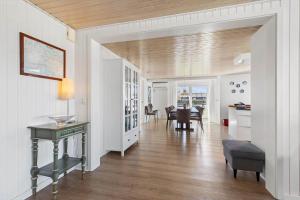 a living room with a table and a dining room at 8501-Grenaa-Ellevej-14 in Grenå Strand