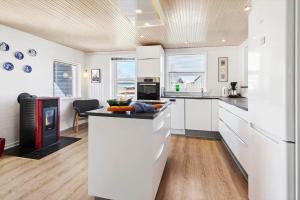 a kitchen with white cabinets and a counter top at 8501-Grenaa-Ellevej-14 in Grenå Strand +18 photos