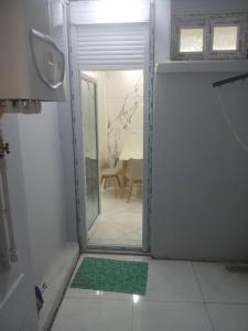 a bathroom with a door open to a room at La perle de Sétif in Sétif