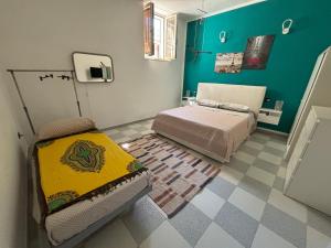 a small bedroom with a bed and a tiled floor at La Portella in Ischitella