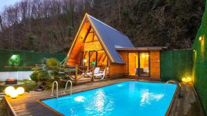 a house with a swimming pool in front of it at Vice Suit Bungalov in Sapanca
