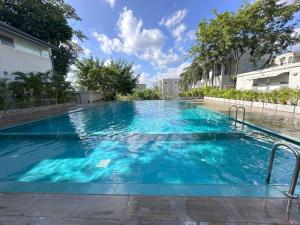 a large swimming pool with blue water at Urban Nest Studio in Homagama