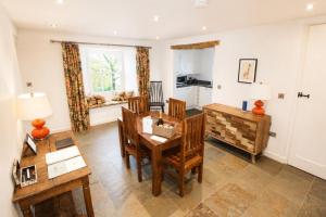 a living room with a table and chairs at Red Squirrel Cottage, Hutton luxurious cottage in a rural setting 10 minutes to Ullswater 15 minutes to Keswick in Penruddock
