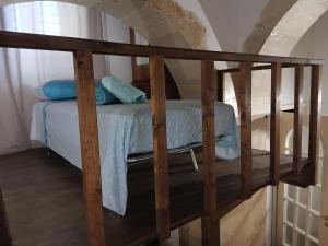 a wooden bunk bed with blue pillows on it at Il Cortile Magico in Syracuse