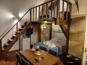 a bedroom with a bunk bed and a table in a room at Il Cortile Magico in Syracuse