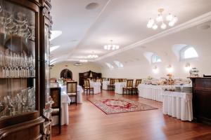 a dining room with white tables and chairs at Hotel Bojnický vínny dom in Bojnice