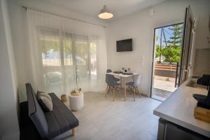 a living room with a couch and a table at Studios Kerasioti in Pefki