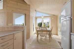 a kitchen with a table and chairs and a window at 30729-Odder-Alrovej-203-C in Odder +16 photos