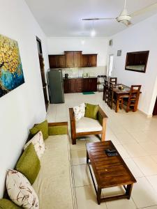 a living room with a couch and a table at Urban Nest Studio in Homagama