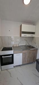 a kitchen with a stove and a sink in it at JMM Apartment in Kotor +14 photos