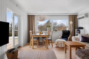 a living room with a table and a couch at 1671-Vejby-Blommevaenget-2 in Vejby
