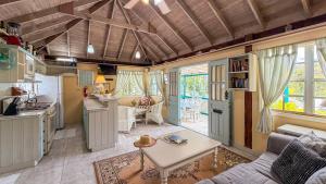 a kitchen and living room with a couch and a table at Titi Vacation Homes in Cobbs Cross