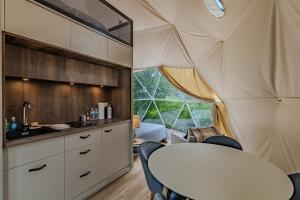 a kitchen and dining room of a tent with a table and chairs at Pilot Mountain Glamping Resort in Pinnacle