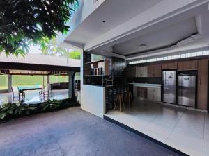 a kitchen with stainless steel appliances in a house at Casa Quinta Locha in Ciudad del Este