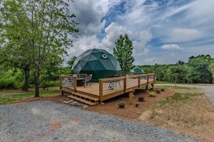 a dome tent sitting on a wooden deck at Pilot Mountain Glamping Resort in Pinnacle