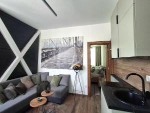 a living room with a couch and a kitchen at Horizont 360 Gold in Vrnjačka Banja