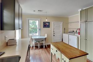a kitchen with a table and a dining room at CB Sunshine Cottage in Carolina Beach +50 photos