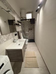 a bathroom with a sink and a toilet and a shower at La Portella in Ischitella +25 photos