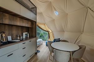 a room in a tent with a table and chairs at Pilot Mountain Glamping Resort in Pinnacle