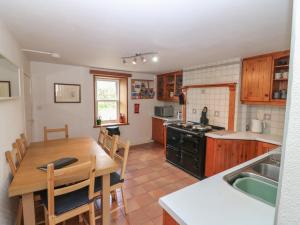 a kitchen and dining room with a table and chairs at Footdee Cottage in Aberdeen +29 photos
