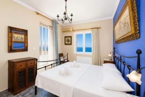a bedroom with two beds and blue walls at Villa Penelope Sea View in Argostoli +18 photos
