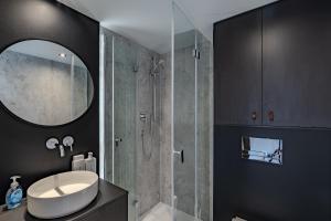 a bathroom with a sink and a shower with a mirror at Pilot Mountain Glamping Resort in Pinnacle +141 photos