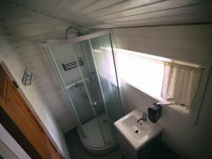 a bathroom with a shower and a sink at Ásgarður Guesthouse in Hvolsvöllur
