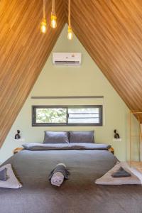 a bedroom with a large bed in a attic at Coco Nest in Ko Phangan +23 photos
