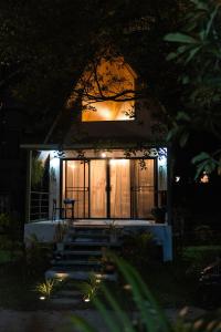 a small house at night with the lights on at Coco Nest in Ko Phangan